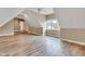 Large bonus room with vaulted ceilings and a view of the hallway with stairs at 6610 Royal Oakland Dr, Indianapolis, IN 46236