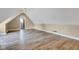Spacious bonus room featuring vaulted ceilings and wood-look floors at 6610 Royal Oakland Dr, Indianapolis, IN 46236