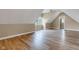 Bonus room showcasing vaulted ceilings, a window, and wood-look floors at 6610 Royal Oakland Dr, Indianapolis, IN 46236