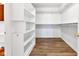 Walk in closet with wooden floors and plentiful shelving for optimal storage solutions at 6610 Royal Oakland Dr, Indianapolis, IN 46236