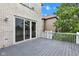 Open-air deck with gray wood flooring and white railing, adjacent to the home's brick exterior at 6610 Royal Oakland Dr, Indianapolis, IN 46236