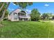 Back exterior view of a two-story brick house with a walkout basement and large lawn at 6610 Royal Oakland Dr, Indianapolis, IN 46236