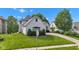 A single-Gathering home features a painted brick exterior, gray roof and manicured lawn at 6610 Royal Oakland Dr, Indianapolis, IN 46236