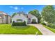 An attractive single-Gathering home features a painted brick exterior and meticulously landscaped lawn at 6610 Royal Oakland Dr, Indianapolis, IN 46236
