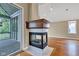 Elegant fireplace with a wooden mantel and access to a screened-in porch with ample space at 6610 Royal Oakland Dr, Indianapolis, IN 46236