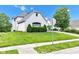 The front of the home has lovely shrubs along the foundation and a manicured lawn at 6610 Royal Oakland Dr, Indianapolis, IN 46236
