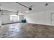 Spacious garage with concrete flooring, window and two recycling containers at 6610 Royal Oakland Dr, Indianapolis, IN 46236