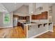 Modern kitchen with stainless steel appliances, breakfast bar, and hardwood floors at 6610 Royal Oakland Dr, Indianapolis, IN 46236