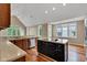 Well-lit kitchen with center island, wooden floors and stainless steel appliances at 6610 Royal Oakland Dr, Indianapolis, IN 46236