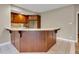 Basement kitchen featuring a bar with countertop and wood cabinets at 6610 Royal Oakland Dr, Indianapolis, IN 46236