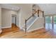 Open-concept living space showcases gleaming hardwood floors, a staircase, and access to multiple rooms at 6610 Royal Oakland Dr, Indianapolis, IN 46236