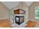 Living room featuring a corner fireplace, hardwood floors, vaulted ceilings, and lots of natural light at 6610 Royal Oakland Dr, Indianapolis, IN 46236