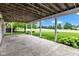 Spacious covered patio with concrete flooring, offering views of the backyard and surrounding landscape at 6610 Royal Oakland Dr, Indianapolis, IN 46236
