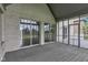 A home's screened porch features a gray wood floor and multiple access points at 6610 Royal Oakland Dr, Indianapolis, IN 46236