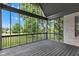 A screened porch with a painted wood floor offers views of the beautifully landscaped yard at 6610 Royal Oakland Dr, Indianapolis, IN 46236