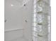 Bright shower featuring a glass block wall, built-in bench, and white tile at 6610 Royal Oakland Dr, Indianapolis, IN 46236