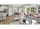 Bright, open-concept living room featuring hardwood floors, dining area, and large windows at 6702 Halsey St, Zionsville, IN 46077