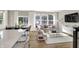 Bright open-concept living room with large windows, neutral colors, and hardwood floors at 6702 Halsey St, Zionsville, IN 46077