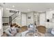 Inviting living room featuring hardwood floors, neutral paint, and a cozy seating area near staircase at 6702 Halsey St, Zionsville, IN 46077