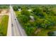 Aerial view of the home and property with surrounding greenery and roadway at 7482 W Us Highway 40, Indianapolis, IN 46229