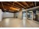 The basement area features exposed wood joists and ductwork, alongside a metal staircase leading to the upper level at 7482 W Us Highway 40, Indianapolis, IN 46229