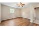 Bedroom with hardwood floors, light walls, and a ceiling fan at 7482 W Us Highway 40, Indianapolis, IN 46229