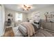 Cozy bedroom with decorative rug, modern furnishings, natural light, and light walls at 7482 W Us Highway 40, Indianapolis, IN 46229
