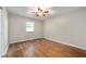 Bedroom with hardwood floors, light walls, and ceiling fan at 7482 W Us Highway 40, Indianapolis, IN 46229