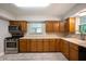 Kitchen with wood cabinets, laminate countertops, and stainless steel appliances at 7482 W Us Highway 40, Indianapolis, IN 46229