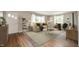 Well lit living room with hardwood floors, a large area rug, and neutral paint to showcase decor at 7482 W Us Highway 40, Indianapolis, IN 46229