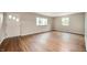 Living room with light walls, hardwood floors, and natural light at 7482 W Us Highway 40, Indianapolis, IN 46229