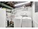 Basement laundry area with washer and dryer and white shelving at 8641 Cholla Rd, Indianapolis, IN 46240