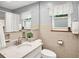 Bathroom featuring natural light, tiled walls, and a tiled floor at 8641 Cholla Rd, Indianapolis, IN 46240