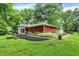 This attractive single story has vibrant landscaping, a patio, and an inviting sunroom addition at 8641 Cholla Rd, Indianapolis, IN 46240