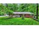Charming brick ranch with well-maintained landscaping and inviting curb appeal in a serene, wooded setting at 8641 Cholla Rd, Indianapolis, IN 46240