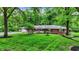 Traditional brick home with a long driveway, mature landscaping, and a welcoming front porch at 8641 Cholla Rd, Indianapolis, IN 46240
