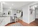 Bright kitchen boasts marble countertops, stainless steel appliances and breakfast bar with charming wooden floors at 8641 Cholla Rd, Indianapolis, IN 46240