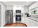 Bright kitchen with stainless steel appliances, white cabinets, and granite countertops, ready for cooking and entertaining at 8641 Cholla Rd, Indianapolis, IN 46240