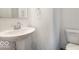 Cozy powder room featuring a pedestal sink and a toilet at 8715 Hollander Dr, Camby, IN 46113