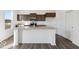 Modern kitchen with a granite countertop island, stainless steel appliances, and dark cabinetry at 8715 Hollander Dr, Camby, IN 46113