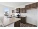 Bright kitchen boasts stainless appliances, an island with a sink, and dark wood cabinetry at 8715 Hollander Dr, Camby, IN 46113
