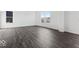 Spacious open-concept living area featuring gorgeous hardwood floors and abundant natural light at 8715 Hollander Dr, Camby, IN 46113