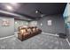 Home theater room with tiered seating, plush leather recliners, and ambient lighting for immersive entertainment at 8802 W 86Th St, Indianapolis, IN 46278