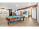Spacious basement featuring a billiard table, access to stairs, and an adjacent bathroom with neutral tones at 8802 W 86Th St, Indianapolis, IN 46278