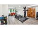 Basement gym area with a variety of exercise machines and adjacent seating area with natural light at 8802 W 86Th St, Indianapolis, IN 46278
