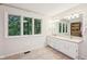 Bright bathroom with double vanity, large windows, and rustic sliding door at 8802 W 86Th St, Indianapolis, IN 46278