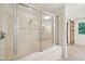 Bright bathroom with large glass shower featuring tub, tile flooring and a sliding barn door at 8802 W 86Th St, Indianapolis, IN 46278