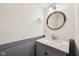 Half bathroom showcasing a modern sink vanity with granite countertop, stylish mirror, and updated fixtures at 8802 W 86Th St, Indianapolis, IN 46278