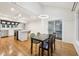 Bright dining room area open to kitchen, with wood floors, modern light fixture, and white walls at 8802 W 86Th St, Indianapolis, IN 46278