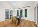 Bright dining room with wood floors, modern light fixture, and sliding door access to balcony at 8802 W 86Th St, Indianapolis, IN 46278